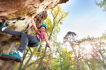 Young camper rock-climbing