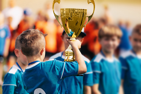 Youth player holding trophy